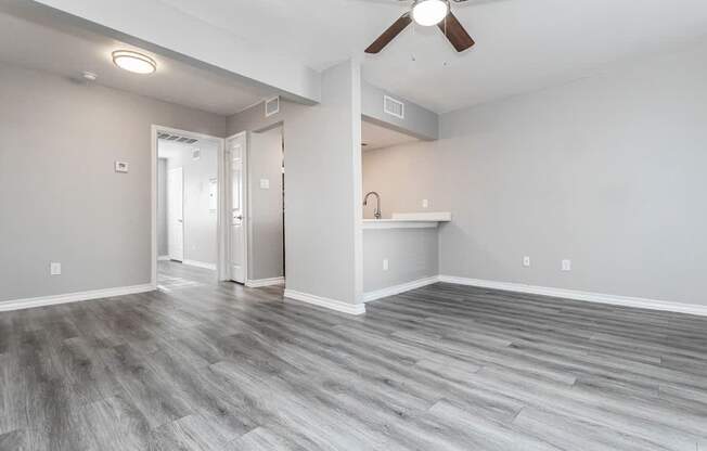 A room with a ceiling fan and light fixture.