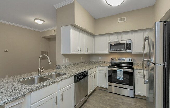 Fully Equipped Kitchen with Fridge, Microwave, and Stove Featuring Granite Countertops