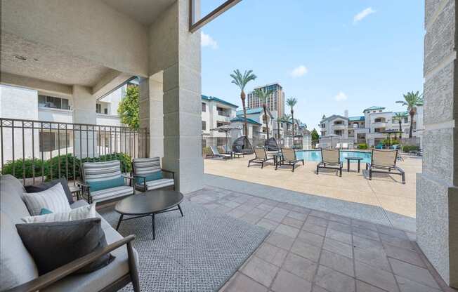 Exterior resort sytle pool and spa patio with chairs and tables