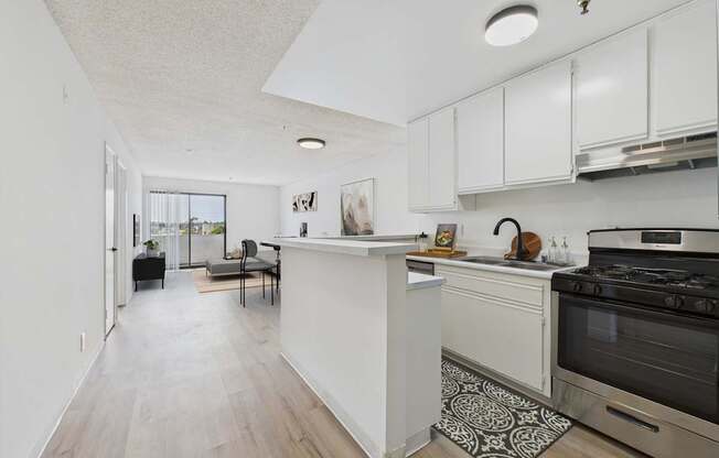 A kitchen with a white counter and a black stove.