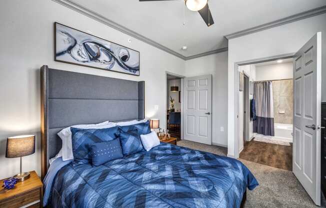 a bedroom with a bed and a ceiling fan