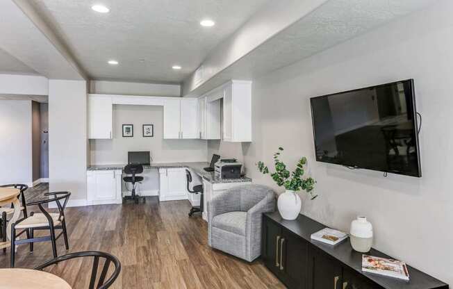 a living room with a tv and a kitchen in the background at The Beckstead, South Jordan, UT, 84095