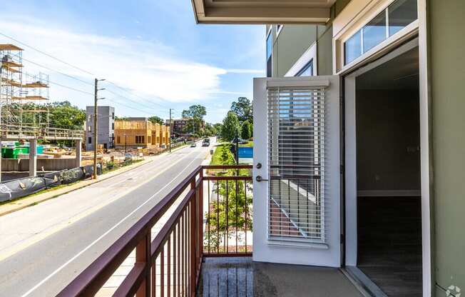 a balcony with a door and a street