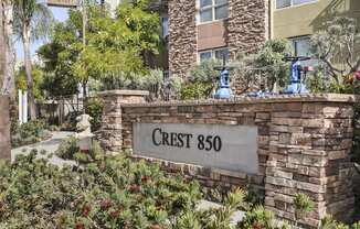 a stone wall with a sign that reads crest 860 in front of a building