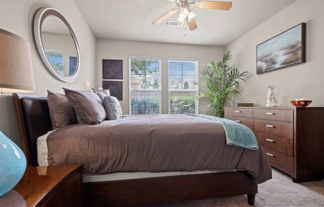 a bedroom with a large bed and a ceiling fan