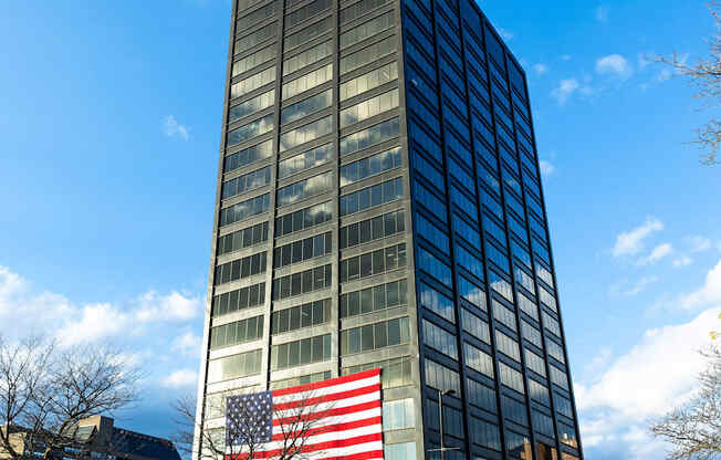 a large flag in front of a tall building