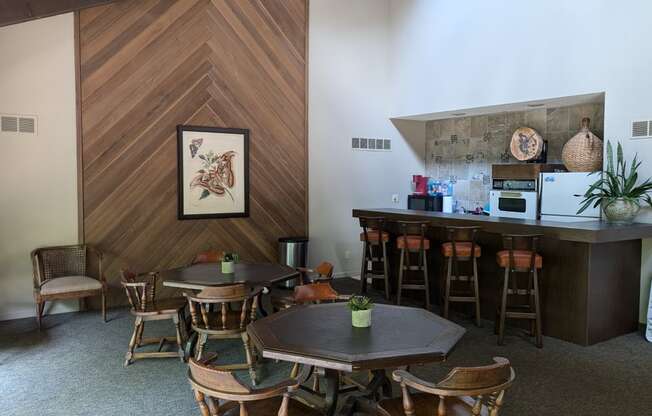 a dining room with tables and chairs and a bar