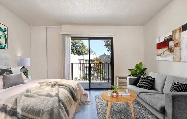 a bedroom with a bed and a couch in front of a sliding glass door  at Sherway Villa, Reseda, California