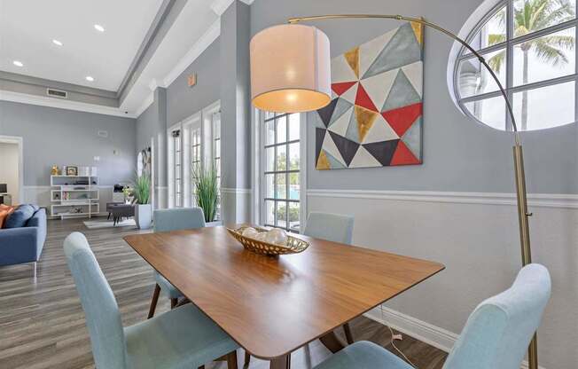 a dining room with a table and chairs and a lamp