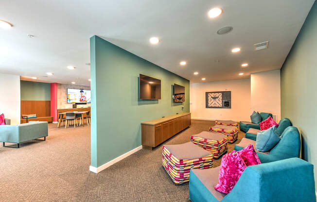 a living room with couches and chairs and a tv at Pinnacle Apartments, Jacksonville