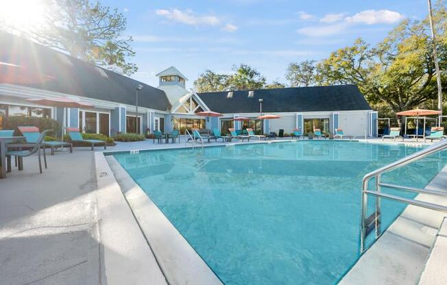 a large swimming pool with a building in the background