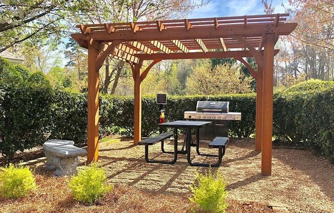 Trellised Outdoor Social & Picnic Areas surrounded by lush landscaping at Autumn Park Apartments, Charlotte, NC 28262