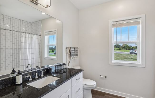 a white bathroom with a sink and a toilet