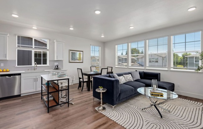 an open living room and kitchen with a couch and a table
