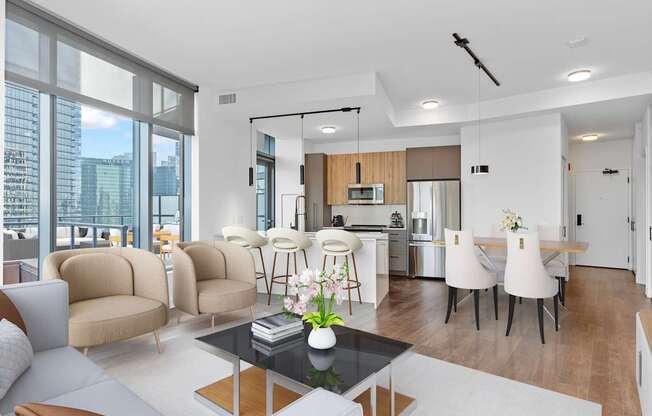 a living room with a couch and a table and a kitchen at Cassidy on Canal, Chicago, 60606