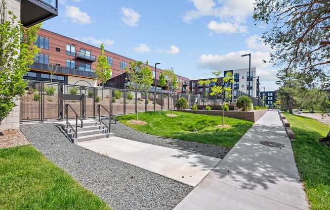A walkway with a metal fence and steps leading to a building.