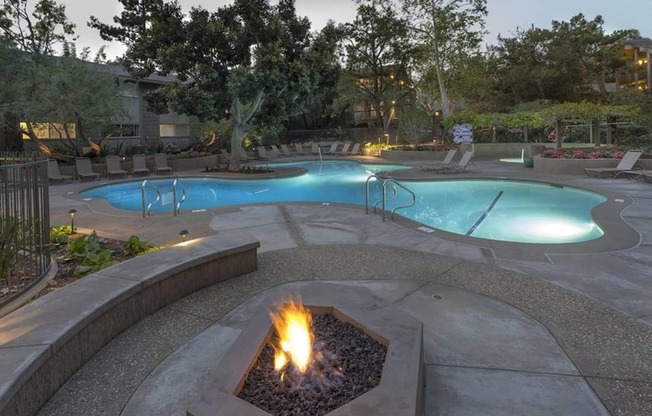 a swimming pool with a fire pit