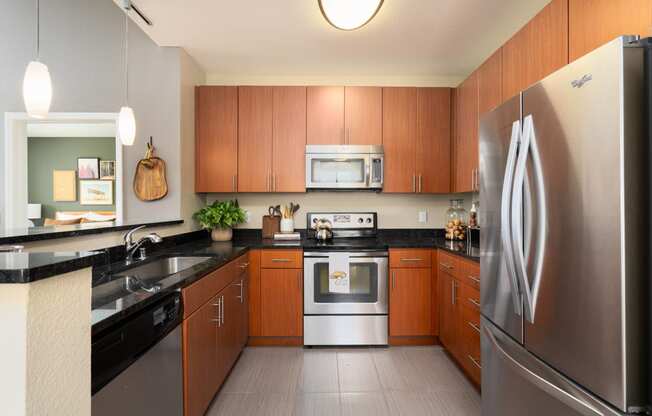 a modern kitchen with stainless steel appliances and wooden cabinets