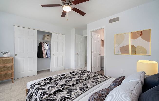 a bedroom with a bed and a ceiling fan