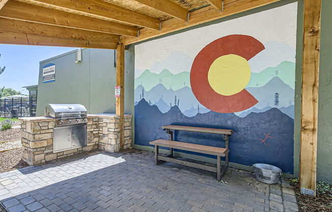 a picnic table in front of a mural on a building