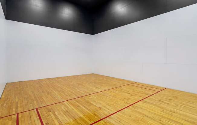 an empty gym with a racquetball court and a wooden floor at Mirasol Apartments, Las Vegas, 89119