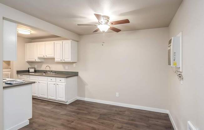 Open dining area with wood-style flooring at Quartz Creek Apartments in Mountlake Terrace, WA