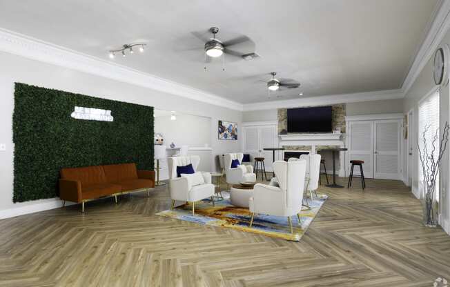 a living room with white furniture and a green wall