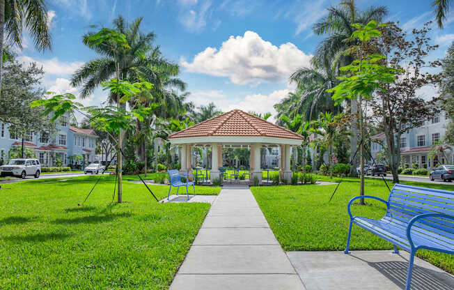 A park with a gazebo, benches, and trees at Floresta apartments in Jupiter, FL