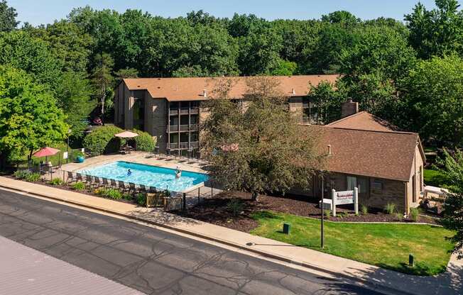 A house with a pool in front of it.