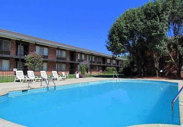 a large blue pool in front of a building