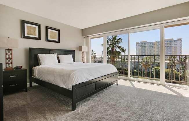 Bedroom with carpet floorings, large balcony, large windows and great views