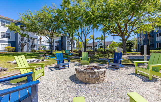 a fire pit and benches at the enclave at woodbridge apartments in sugar land, tx