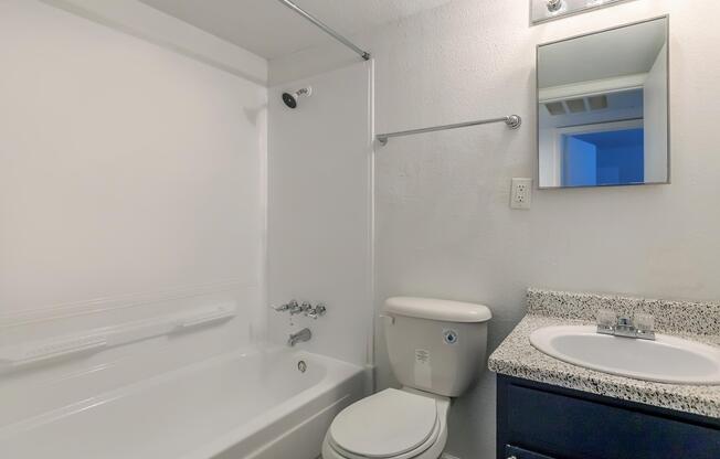 a white tub sitting next to a sink