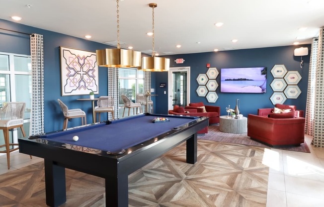 a spacious game room with a pool table and couches