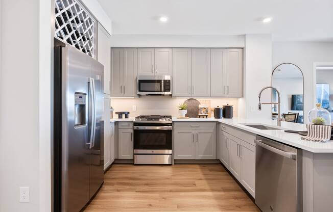 a kitchen with stainless steel appliances and white cabinets