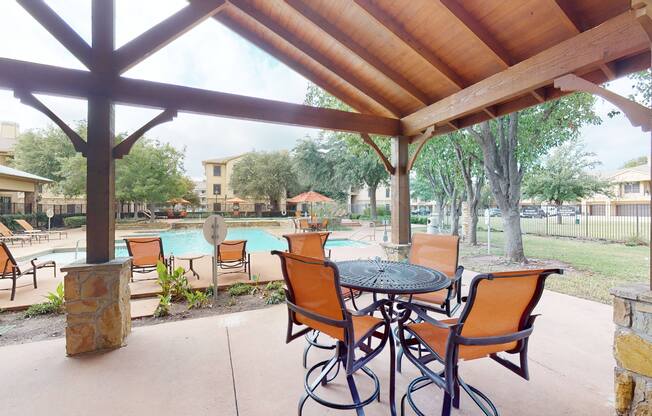 Outdoor lounge and poolside seating at The Canyons Apartments, Fort Worth, 76116