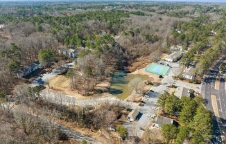 an aerial view of a neighborhood with a pool and trees