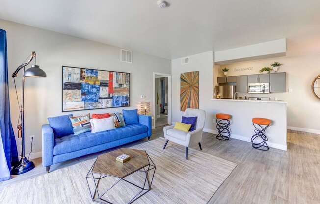 A living room with a blue couch and a coffee table.