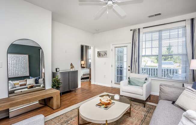 a living room with white walls and hardwood floors