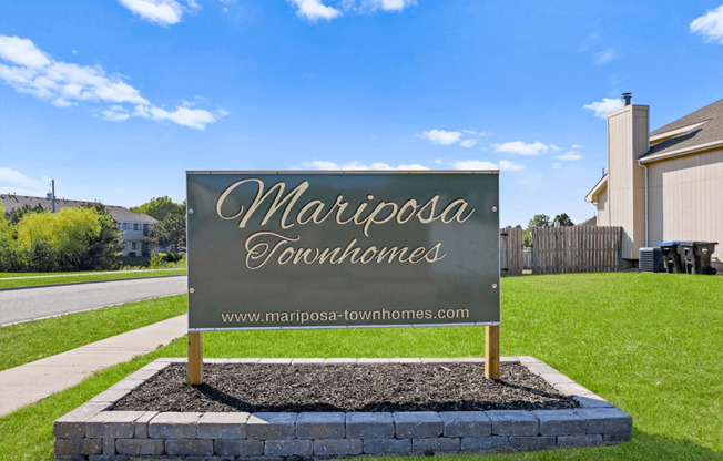 a sign for mariposa vacations in front of a house