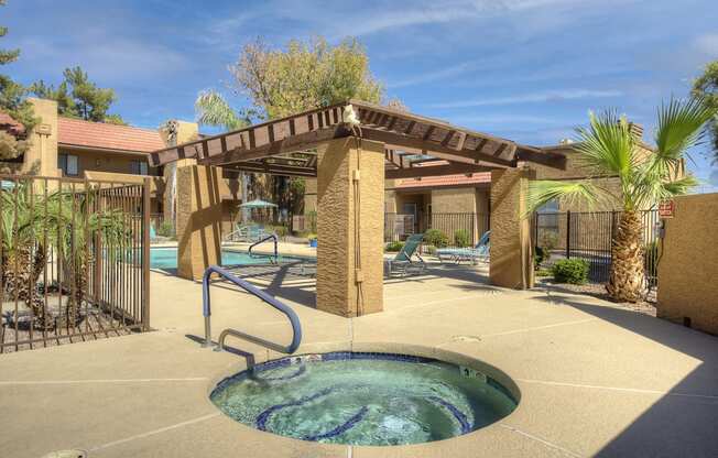 a jacuzzi with a pool in a courtyard with a resort style pool