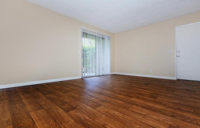 a large empty room with a wood floor