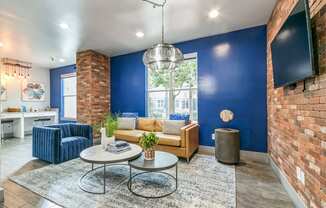 a living room with a blue wall and a couch and a table