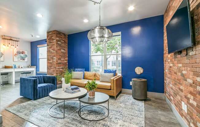 a living room with a blue wall and a couch and a table