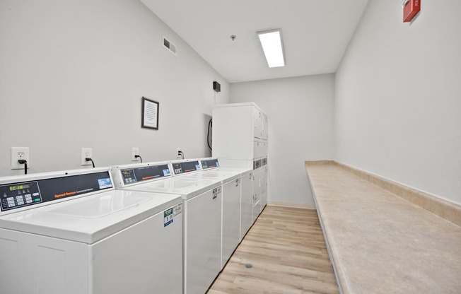 A laundry room with washers and dryers.