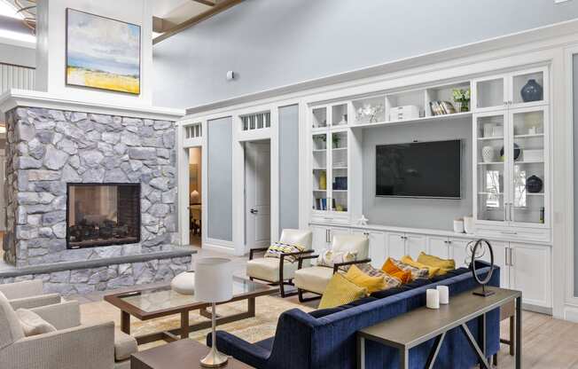 a living room filled with furniture and a large stone fireplace