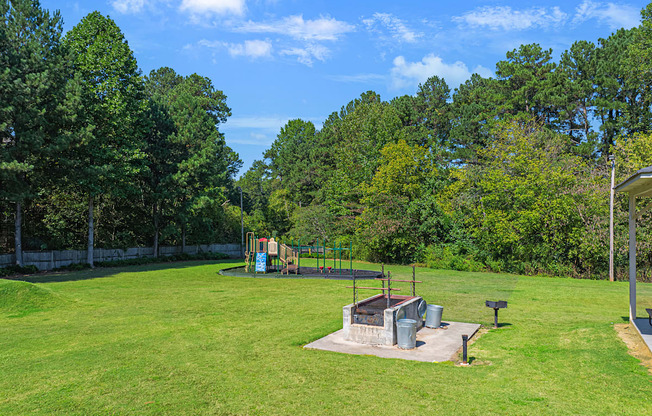 a park with a playground and a fire pit