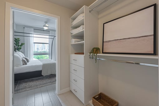a bedroom with a closet and a window with a bed in it
