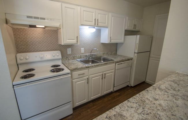 This is a photo of the kitchen of the 752 square foot 1 bedroom apartment with den at The Biltmore Apartments in Dallas, TX.