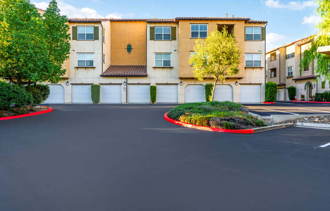 an empty parking lot in front of an apartment building